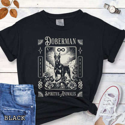 Black Comfort Colors t-shirt featuring a Doberman Pinscher tarot card design with Gothic roses and mystical symbols, perfect for Goth dog lovers and dark aesthetic Doberman fans.