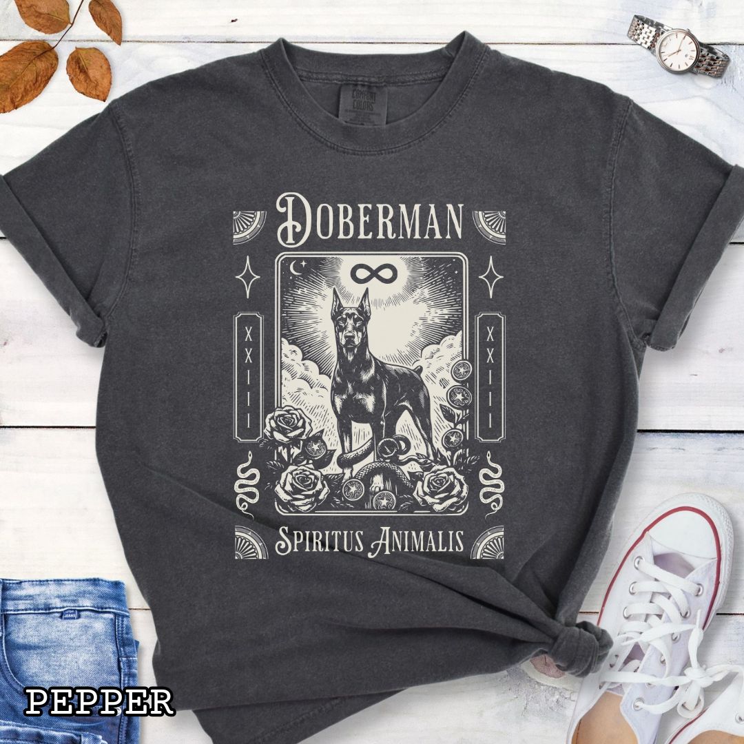 Dark grey Comfort Colors t-shirt featuring a Doberman Pinscher tarot card design with Gothic roses and mystical symbols, perfect for Goth dog lovers and dark aesthetic Doberman fans.