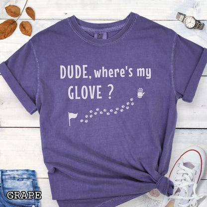 Purple tracking dog t-shirt with flag, paw prints, and glove, and the text 'DUDE, where's my GLOVE?', presented on a wooden surface with accessories.