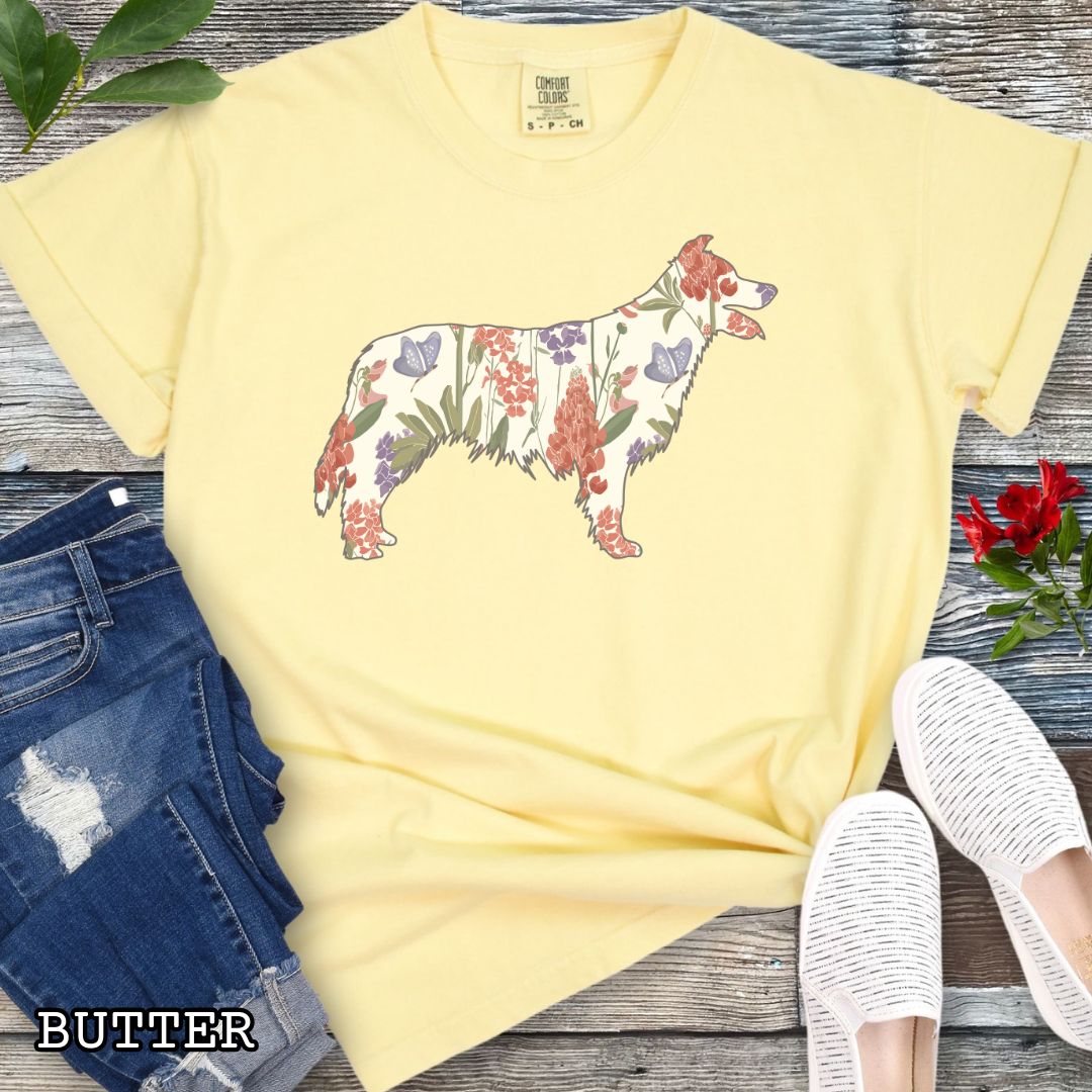 Yellow Comfort Colors t-shirt with floral Border Collie dog design on a wooden surface with jeans and shoes.