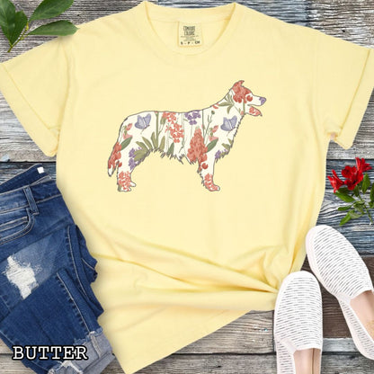 Yellow Comfort Colors t-shirt with floral Border Collie dog design on a wooden surface with jeans and shoes.