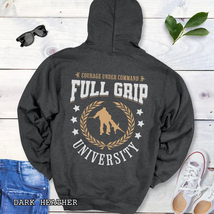 Back view of a dark grey Schutzhund/IGP hoodie with 'Full Grip University' text , laurels, stars and bite work graphic, presented on a wooden surface with jeans and shoes.