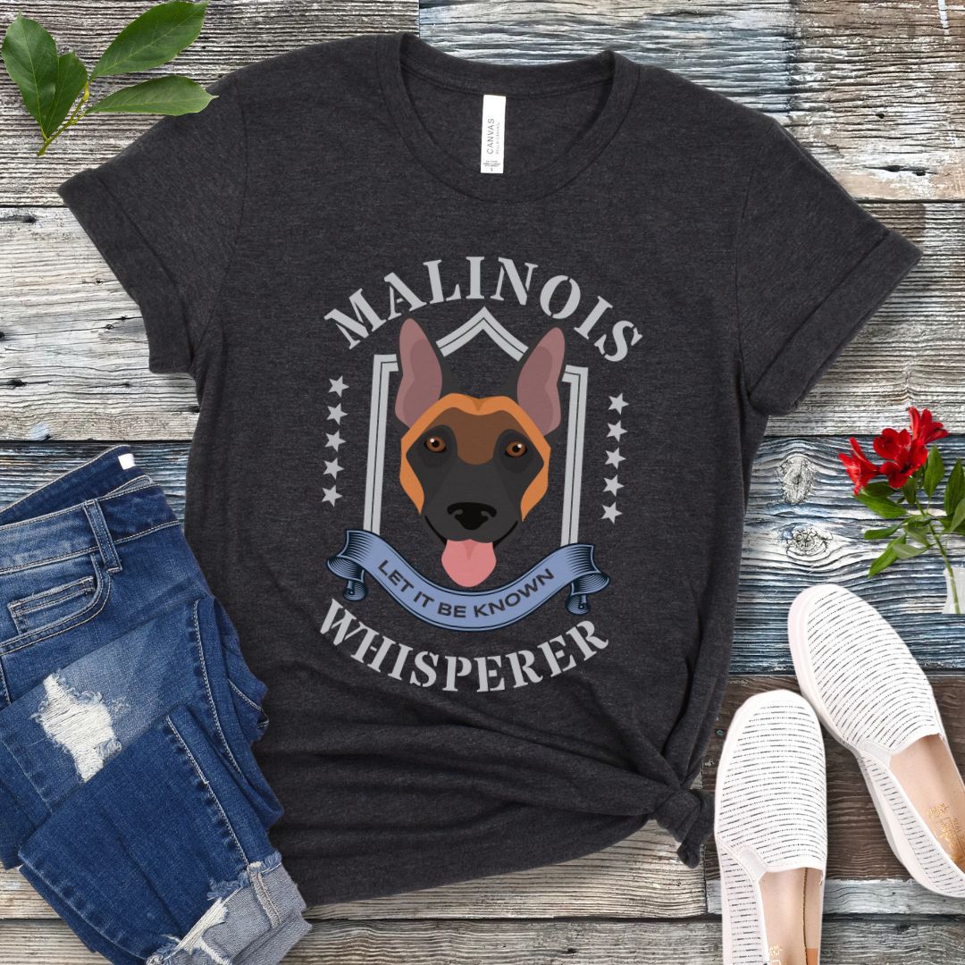 Dark grey unisex Belgian Malinois t-shirt with Malinois face and the text 'Malinois Whisperer, Let It Be Known' in military style lettering. 