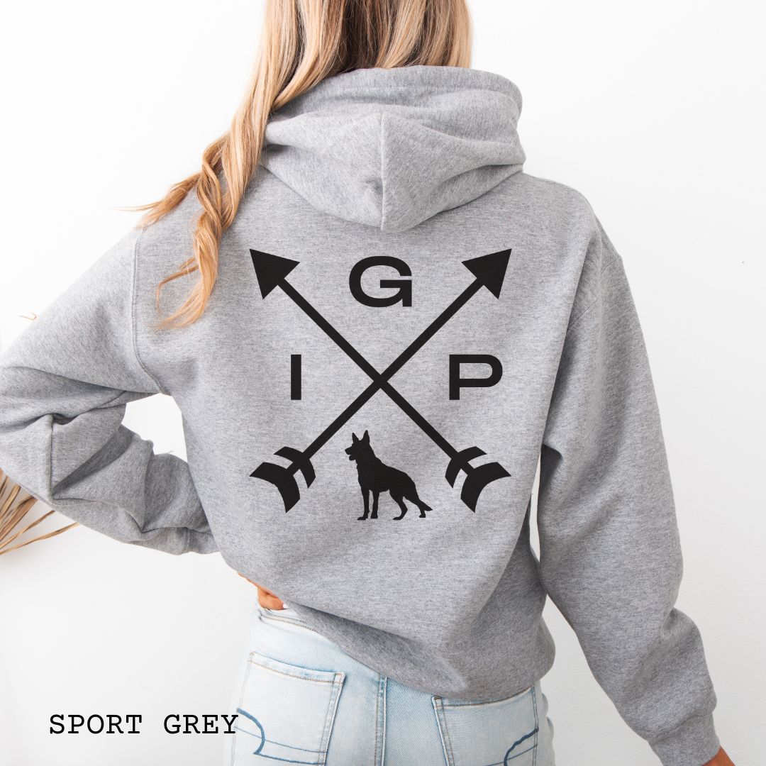 Back view of a grey Schutzhund/IGP hoodie with crossed arrows design with 'IGP' text and German Shepherd silhouette on the back, worn by a person.
