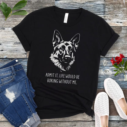 Black t-shirt for German Shepherd lovers with with Shepherd dog face graphic and humorous text 'Admit it. Life would be boring without me'. Shown on a wooden surface with accessories.