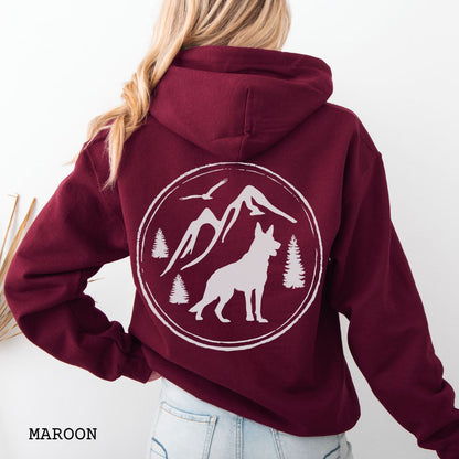 Maroon Gildan 18500 German Shepherd Mountain Adventure hoodie featuring a large vintage-style back print with GSD silhouette, mountains, pine trees, and birds for hiking and outdoor dog lovers.