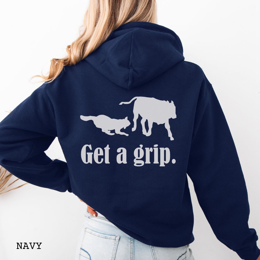 Navy blue back print hoodie with a graphic of a Heeler dog herding a cow and the text 'Get a grip.' Worn by a person.