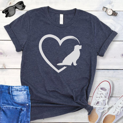 Heather navy t-shirt with the outline of a heart intersected by a sitting Golden Retriever dog silhouette on a wooden surface with jeans and shoes.