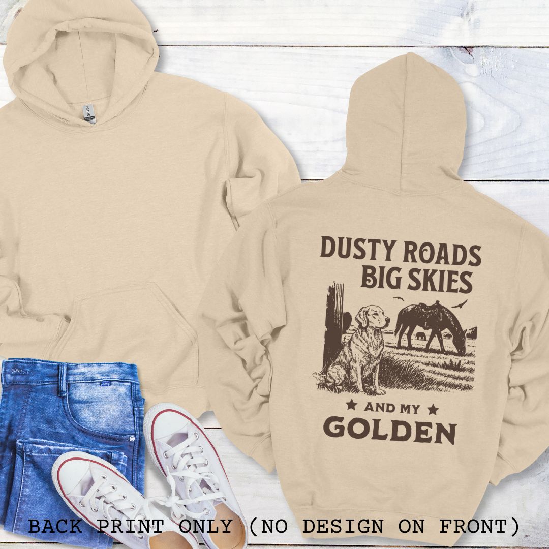 Beige Golden Retriever hoodie with 'Dusty Roads Big Skies and My Golden' print on a wooden surface with jeans and sneakers.