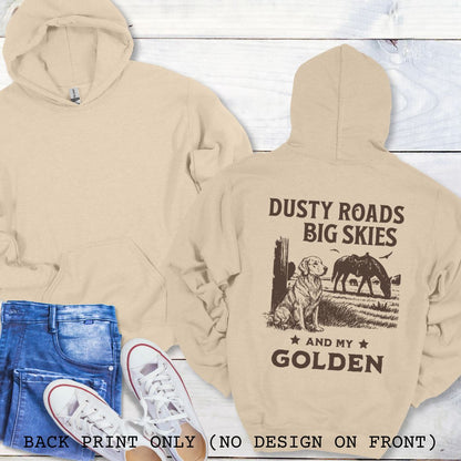 Beige Golden Retriever hoodie with 'Dusty Roads Big Skies and My Golden' print on a wooden surface with jeans and sneakers.