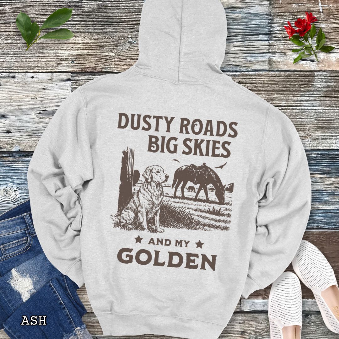 Back view of light gray hoodie featuring a Western-style design with grazing horse, rustic fence, and a Golden Retriever illustration; text reads “Dusty Roads, Big Skies, and My Golden.”