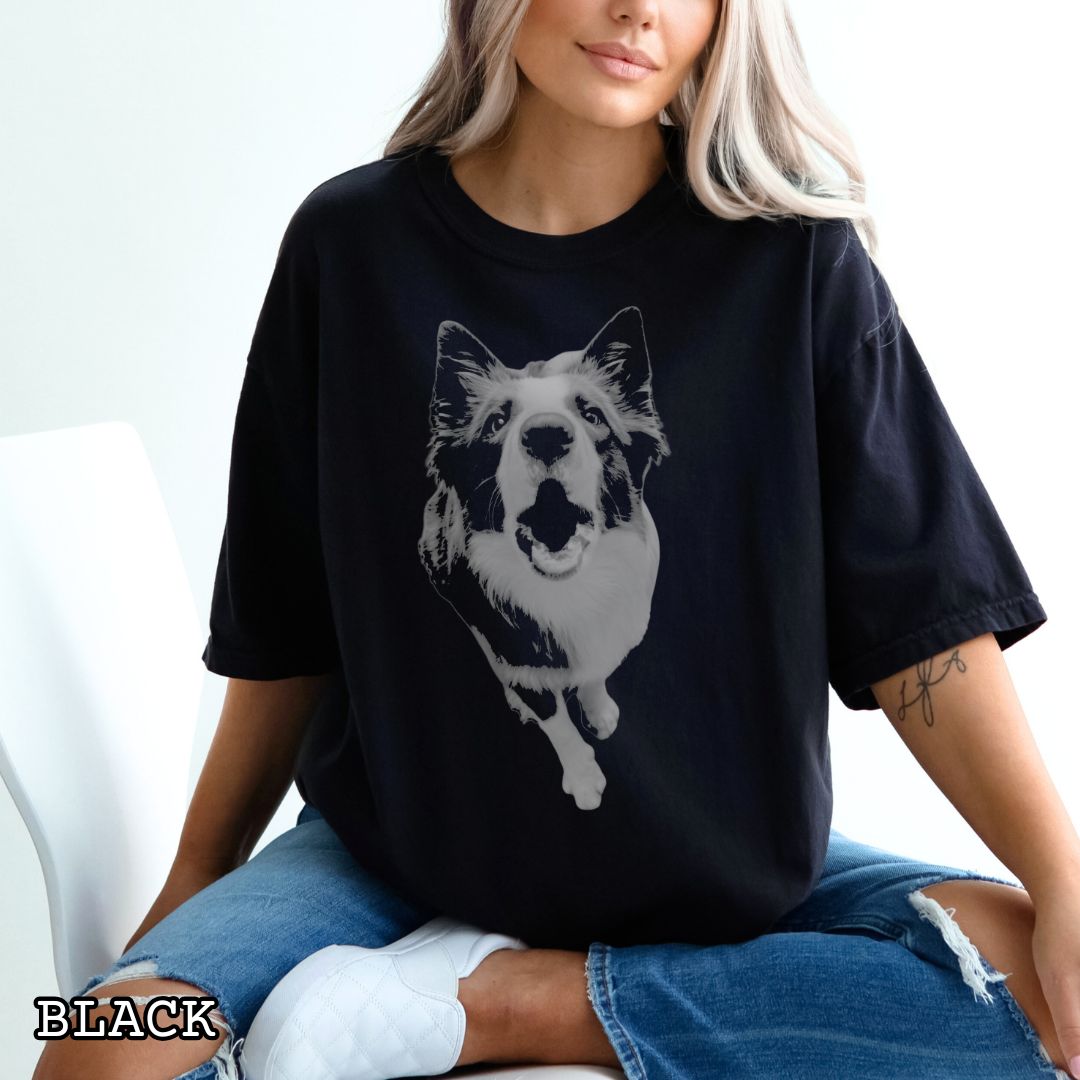 Black Comfort Colors t-shirt with a vintage style monochrome Border Collie dog photo in grunge, streetwear style. Shown on a wooden surface with shoes and jeans.