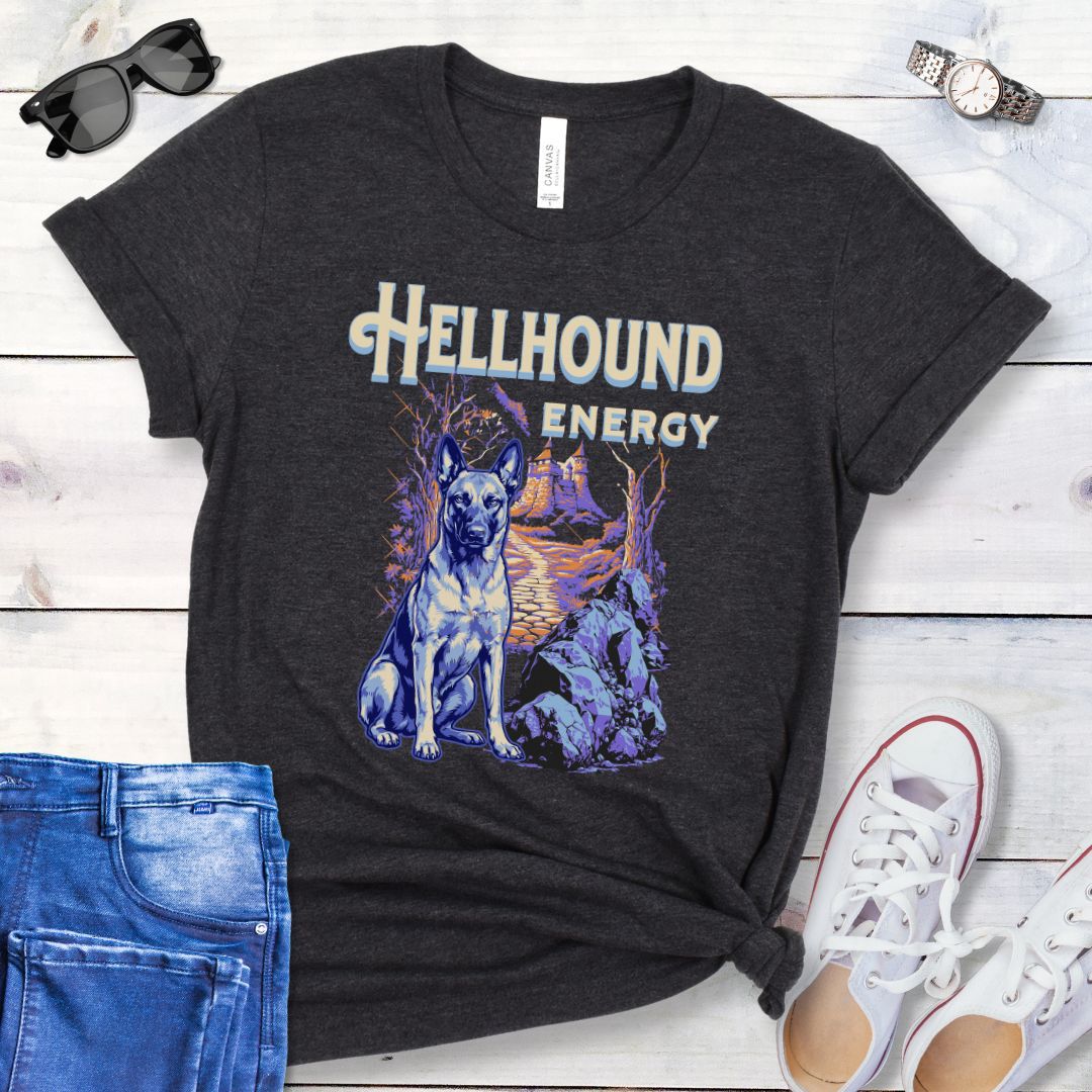 Dark grey Bella Canvas t-shirt featuring a goth-style Belgian Malinois design with haunted landscape, castle and Malinois dog, and the text Hellhound Energy in retro lettering, perfect for working dog lovers, Halloween dog moms, and spooky dog enthusiasts.