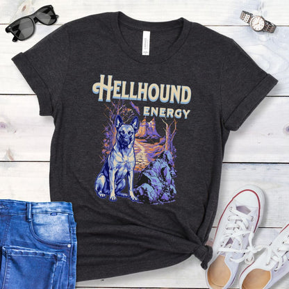 Dark grey Bella Canvas t-shirt featuring a goth-style Belgian Malinois design with haunted landscape, castle and Malinois dog, and the text Hellhound Energy in retro lettering, perfect for working dog lovers, Halloween dog moms, and spooky dog enthusiasts.
