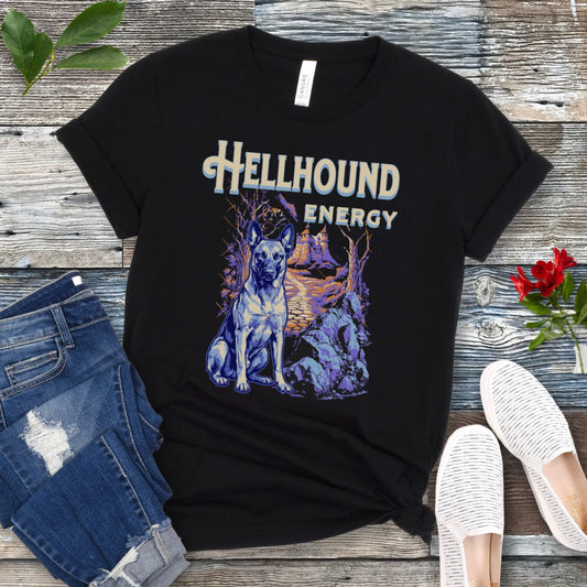 Black Bella Canvas t-shirt featuring a goth-style Belgian Malinois design with haunted landscape, castle and Malinois dog, and the text Hellhound Energy in retro lettering, perfect for working dog lovers, Halloween dog moms, and spooky dog enthusiasts.