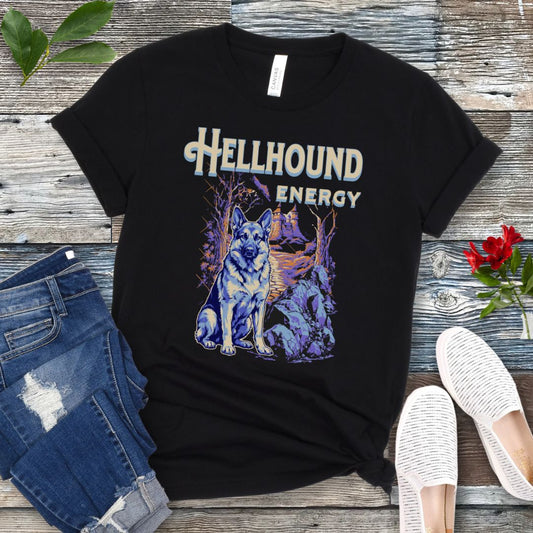 Black Bella Canvas t-shirt featuring a goth-style German Shepherd design with haunted landscape, castle and German Shepherd Dog, and the text Hellhound Energy in retro lettering, perfect for GSD lovers, Halloween dog moms, and spooky dog enthusiasts.