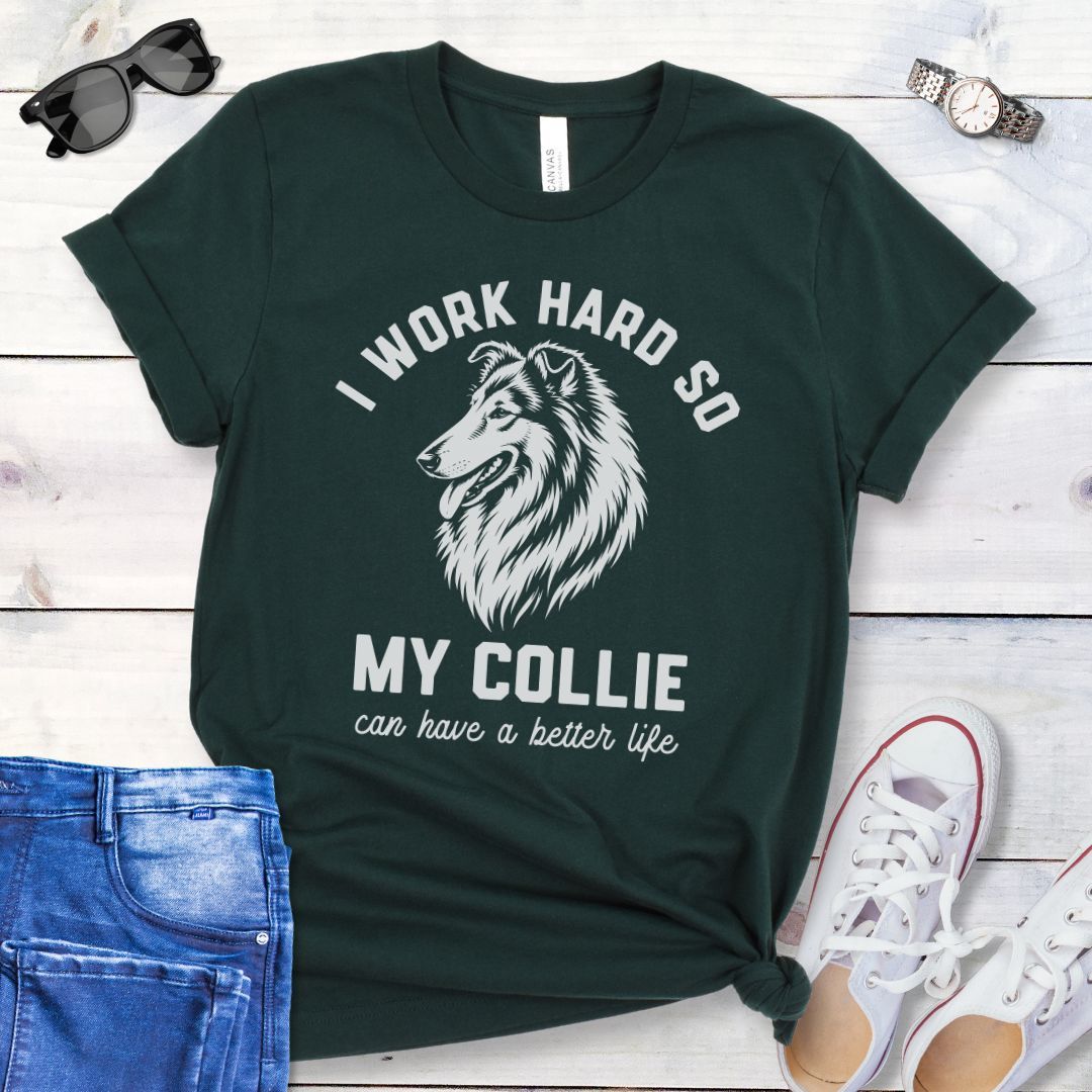 Dark green unisex t-shirt for Rough Collie lovers with linocut-style breed head study graphic and humorous text 'I work hard so my Collie can have a better life', shown on a wooden surface with jeans and shoes. 