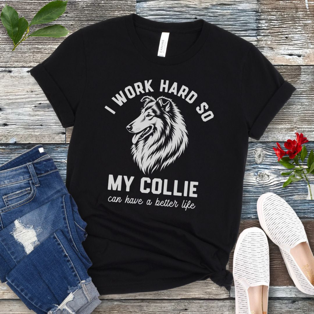 Black unisex t-shirt for Rough Collie lovers with linocut-style breed head study graphic and humorous text 'I work hard so my Collie can have a better life', shown on a wooden surface with jeans and shoes. 