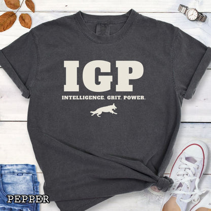 Pepper Comfort Colors t-shirt featuring the IGP Intelligence. Grit. Power. design with working dog silhouette, Schutzhund shirt for IGP competitors, IPO handlers, protection sports enthusiasts, and working dog trainers.