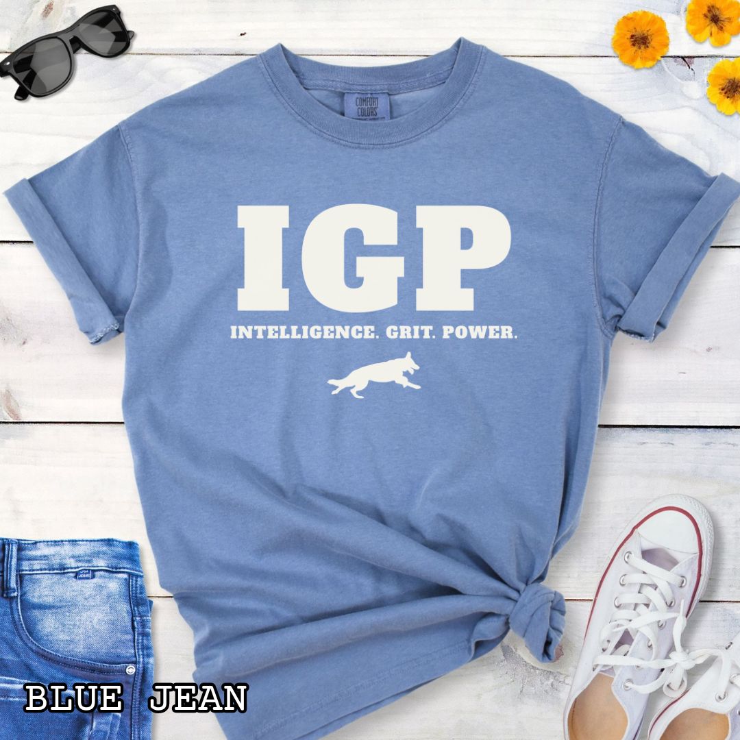 Blue Comfort Colors t-shirt featuring the IGP Intelligence. Grit. Power. design with working dog silhouette, Schutzhund shirt for IGP competitors, IPO handlers, protection sports enthusiasts, and working dog trainers.