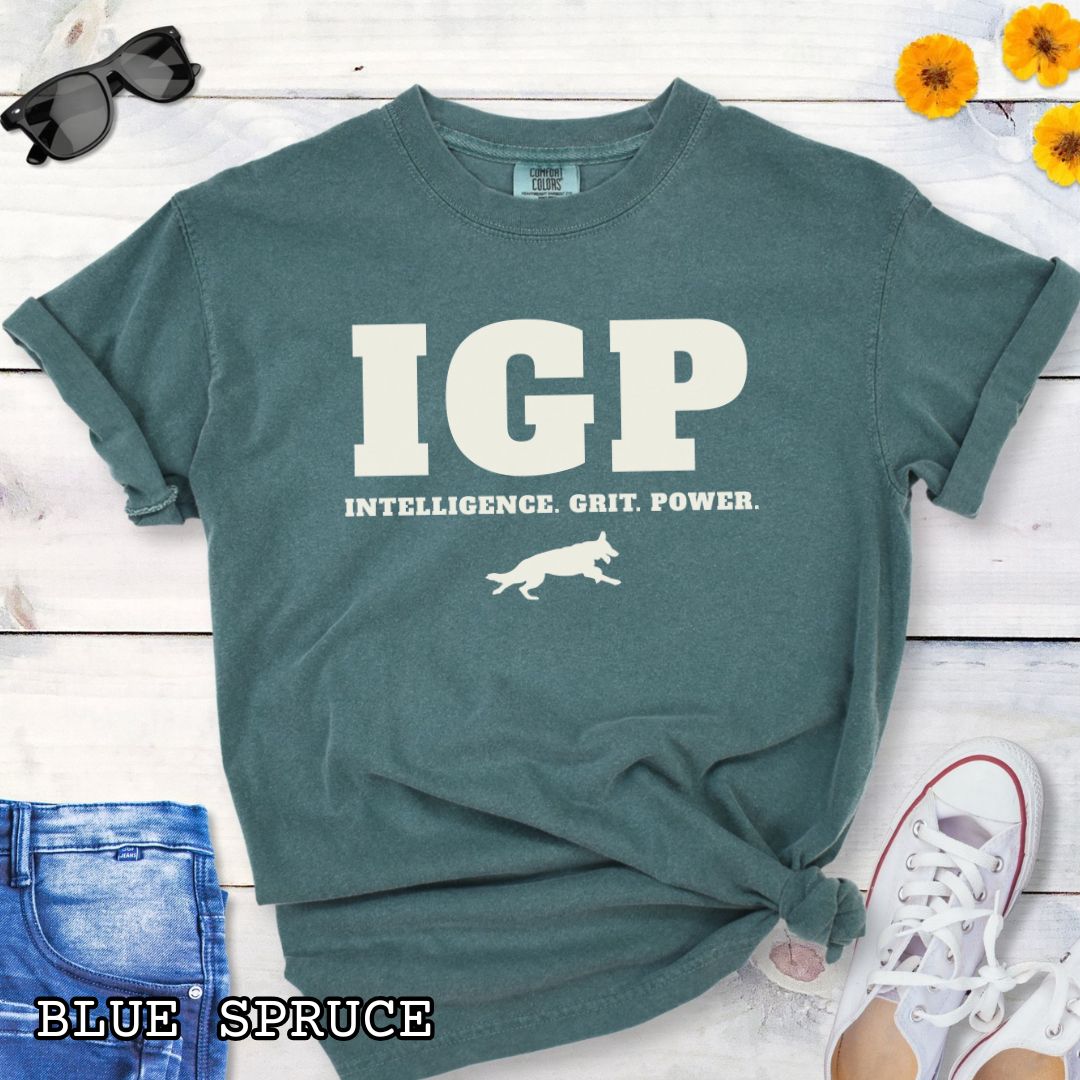 Green Comfort Colors t-shirt featuring the IGP Intelligence. Grit. Power. design with working dog silhouette, Schutzhund shirt for IGP competitors, IPO handlers, protection sports enthusiasts, and working dog trainers.