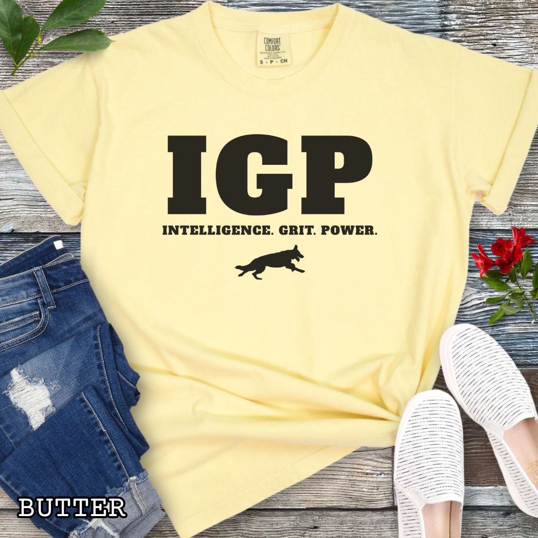 Yellow Comfort Colors t-shirt featuring the IGP Intelligence. Grit. Power. design with working dog silhouette, Schutzhund shirt for IGP competitors, IPO handlers, protection sports enthusiasts, and working dog trainers.