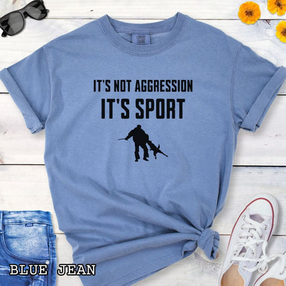 Blue Comfort Colors t-shirt for Schutzhund/IGP bitework dog trainers with 'It's not aggression, it's sport' text and a bite work graphic, shown on a wooden surface.
