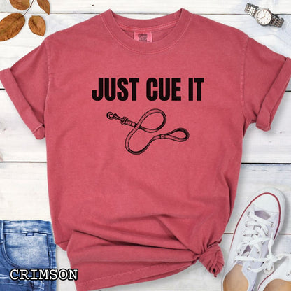 Red Comfort Colors t-shirt featuring a Just Cue It text with leash graphic, a positive reinforcement dog training shirt for dog trainers and reward-based training enthusiasts.
