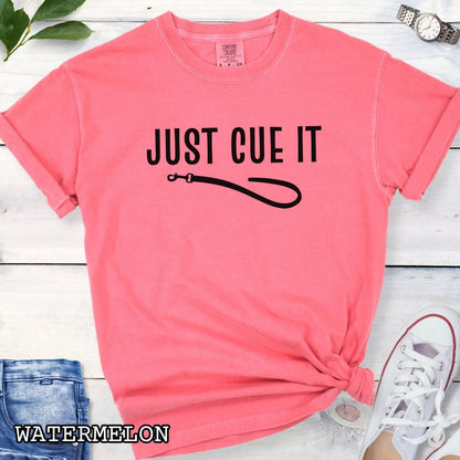Pink Comfort Colors t-shirt featuring a Just Cue It text with leash graphic, a positive reinforcement dog training shirt for dog trainers and reward-based training enthusiasts.