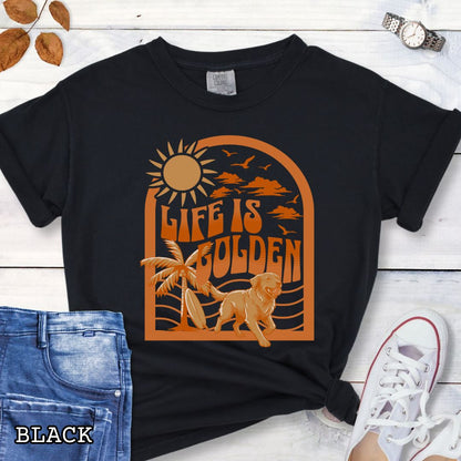 Black Comfort Colors Golden Retriever t-shirt featuring retro tropical sunset design with palm trees, surfboard, and Life Is Golden slogan, perfect for Golden Retriever lovers, beach dog moms, and summer dog lover gifts.