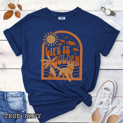 Navy blue Comfort Colors Golden Retriever t-shirt featuring retro tropical sunset design with palm trees, surfboard, and Life Is Golden slogan, perfect for Golden Retriever lovers, beach dog moms, and summer dog lover gifts.