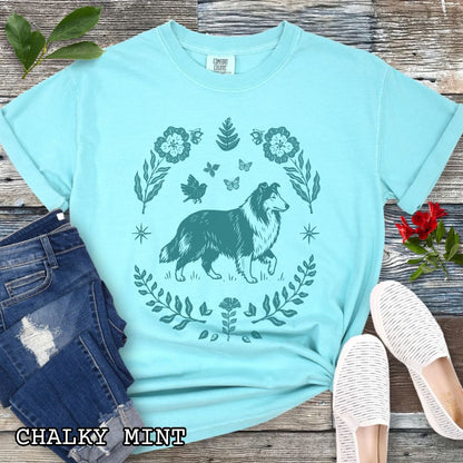 Bright teal Comfort Colors t-shirt with folk art style Rough Collie t-shirt featuring a linocut-inspired collie surrounded by floral and botanical elements in a boho cottagecore design. Perfect dog lover gift for Collie owners.