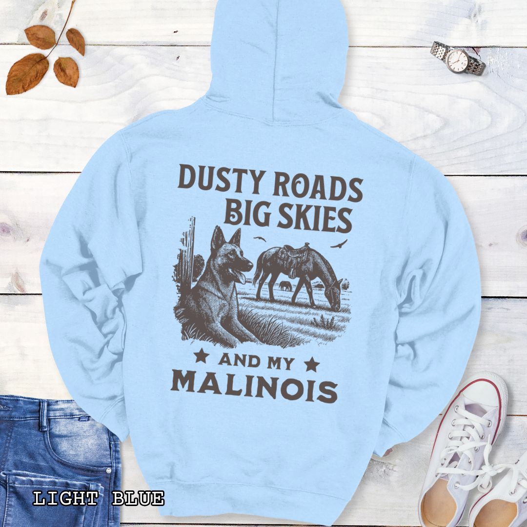Back view of a light blue Belgian Malinois hoodie featuring a Western-style design with grazing horse, rustic fence, and a Malinois illustration; text reads “Dusty Roads, Big Skies, and My Malinois.”