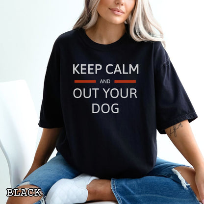 Black Comfort Colors t-shirt for IGP/IPO/Schutzhund dog trainers with 'Keep Calm and Out Your Dog' text, shown on a wooden surface.
