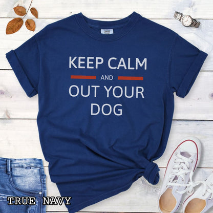 Dark blue Comfort Colors t-shirt for Schutzhund dog trainers with 'Keep Calm and Out Your Dog' text, shown on a wooden surface.