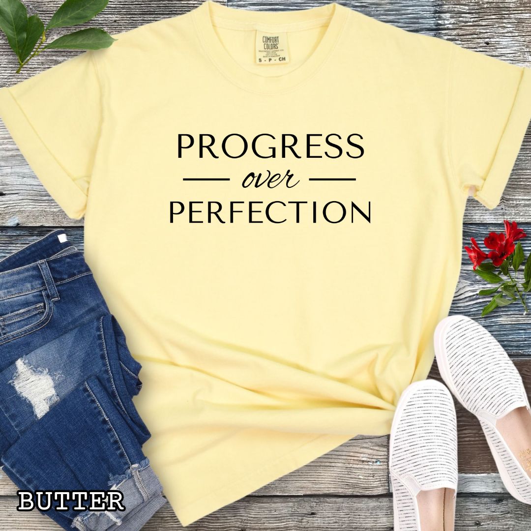 Butter (yellow) Comfort Colors Progress Over Perfection t-shirt featuring a minimalist motivational typography design for dog trainers, dog owners, and dog training enthusiasts.