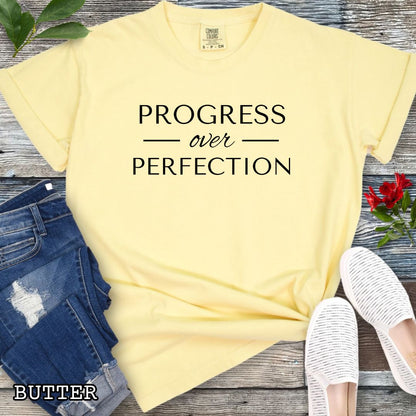 Butter (yellow) Comfort Colors Progress Over Perfection t-shirt featuring a minimalist motivational typography design for dog trainers, dog owners, and dog training enthusiasts.