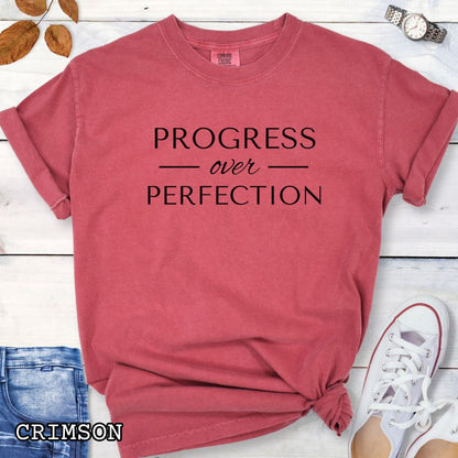 Crimson (red) Comfort Colors Progress Over Perfection t-shirt featuring a minimalist motivational typography design for dog trainers, dog owners, and dog training enthusiasts.