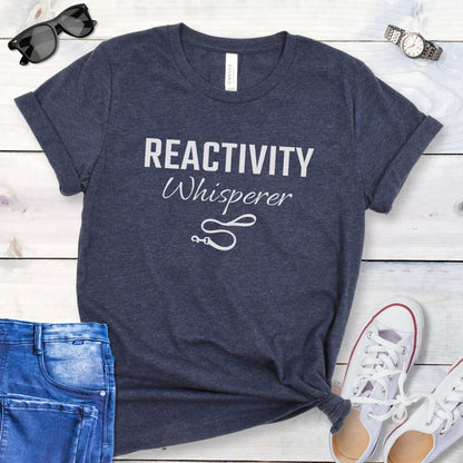 Heather navy blue unisex t-shirt featuring a Reactivity Whisperer  text design with leash graphic, a funny reactive dog trainer shirt for dog training professionals.