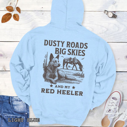 Back view of a light blue Red Heeler hoodie featuring a Western-style design with grazing horse, rustic fence, and an Cattle Dog illustration; text reads “Dusty Roads, Big Skies, and My Red Heeler.”