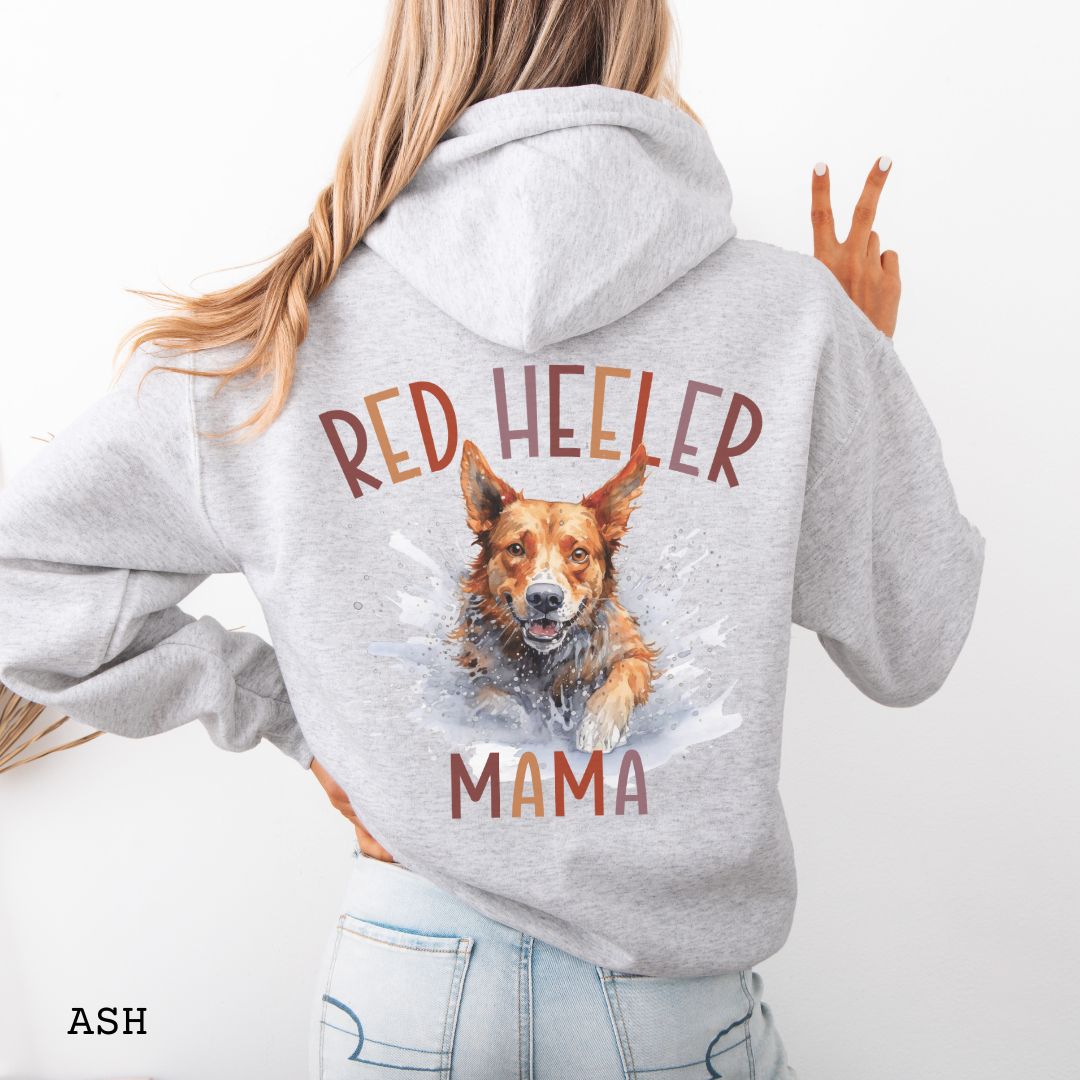 Person wearing a gray Australian Cattle Dog hoodie with 'Red Heeler Mama' text and a Heeler dog watercolor illustration on the back.