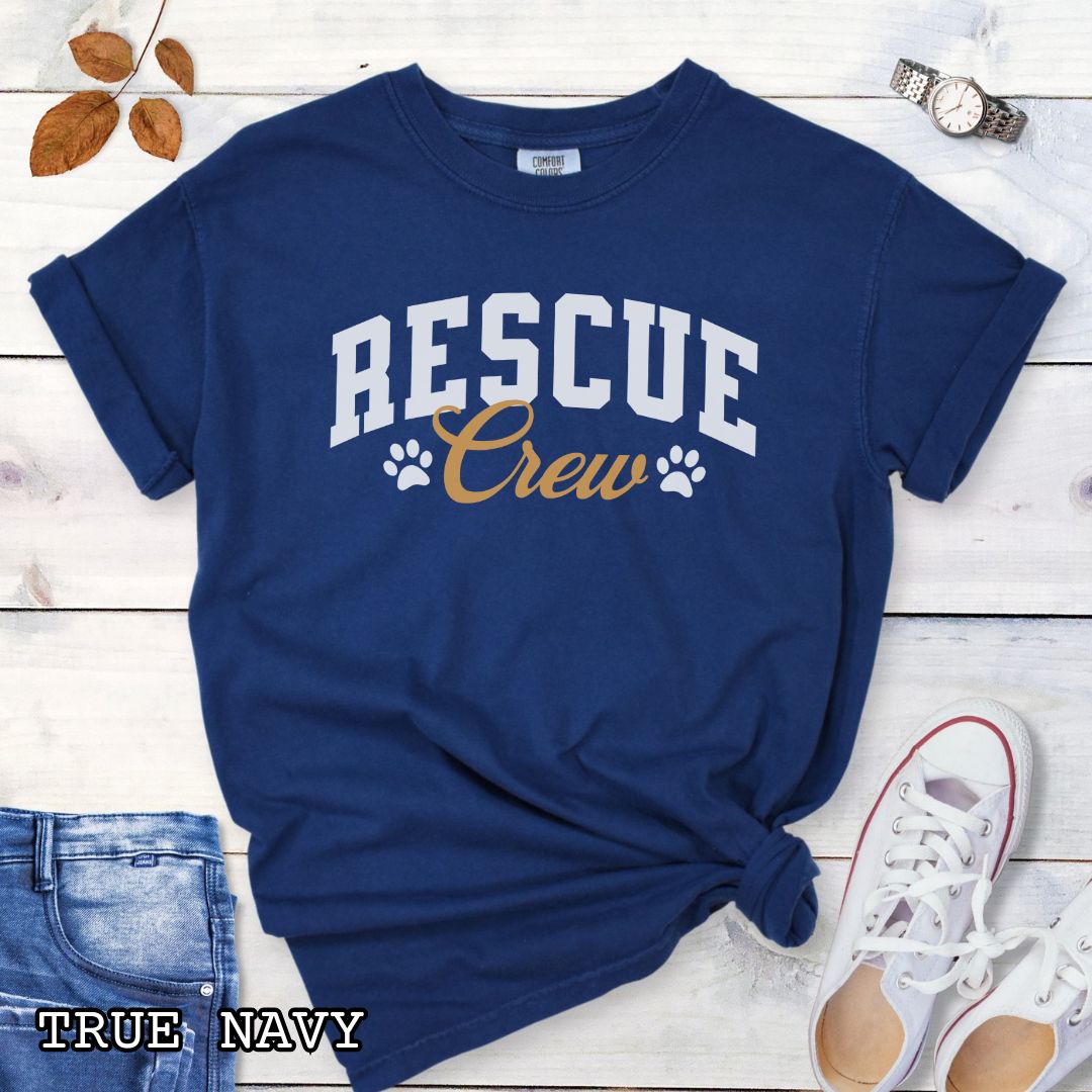 Navy Comfort Colors t-shirt featuring bold college-style Rescue Crew text with paw prints, perfect for rescue dog lovers, dog adoption advocates, fosters, and rescue volunteers.