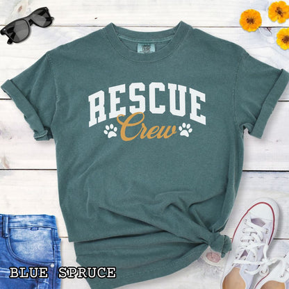 Green Comfort Colors t-shirt featuring bold college-style Rescue Crew text with paw prints, perfect for rescue dog lovers, dog adoption advocates, fosters, and rescue volunteers.