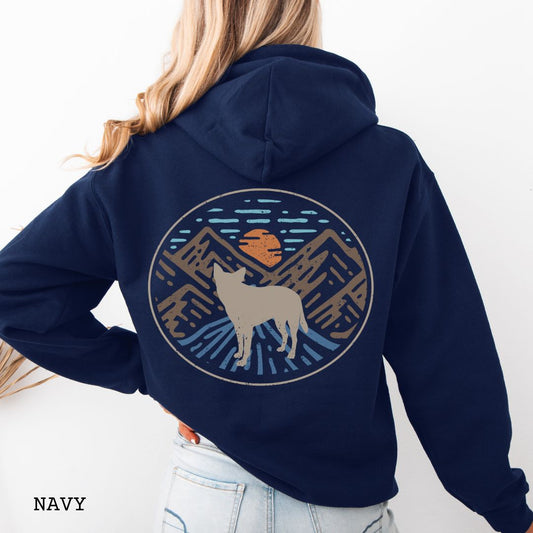 Navy Cattle Dog hoodie with a Heeler and retro mountain design on the back, worn by a person.