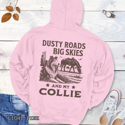 Back view of an light pink Collie hoodie featuring a Western-style design with grazing horse, rustic fence, and a Rough Collie illustration; text reads “Dusty Roads, Big Skies, and My Collie.”
