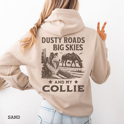 Back view of sand-beige Collie hoodie featuring a Western-style design with grazing horse, rustic fence, and a Rough Collie illustration; text reads “Dusty Roads, Big Skies, and My Collie.”