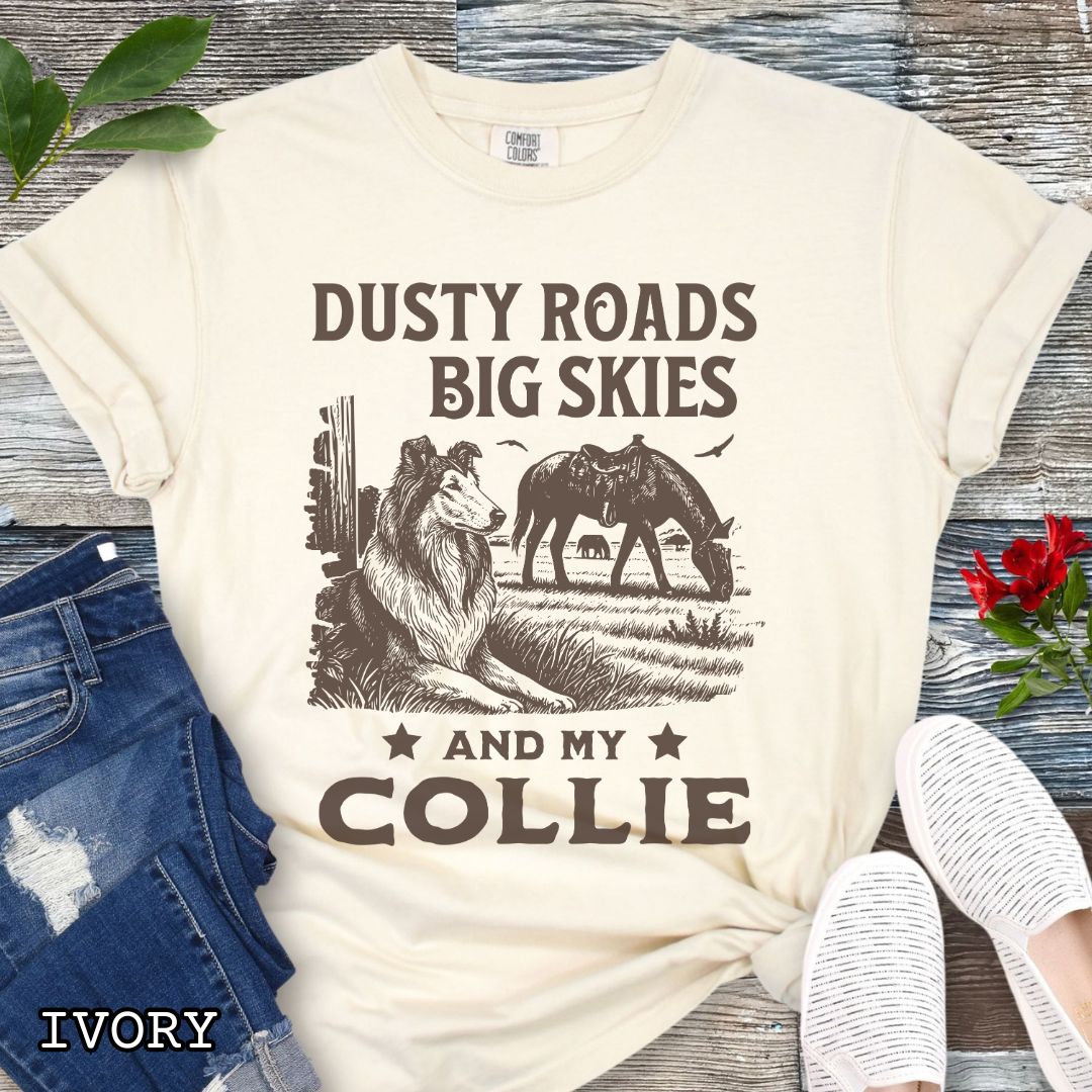 Ivory Comfort Colors t-shirt featuring a Western-style design with grazing horse, rustic fence, and a Rough Collie illustration; text reads “Dusty Roads, Big Skies, and My Collie.”