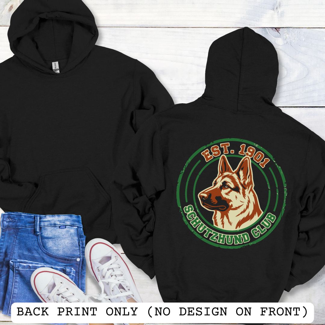 Black back print hoodie with a  German Shepherd Dog and 'Established 1901, Schutzhund Club' text in a circular logo style design, displayed on a wooden surface with flowers and jeans.