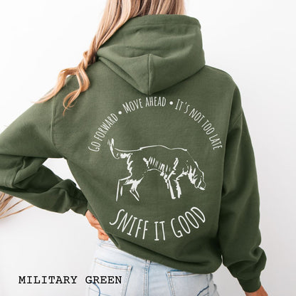 Military green scent work hoodie, seen from the back, with a graphic print of a dog sniffing and text that reads 'Sniff It Good'. 