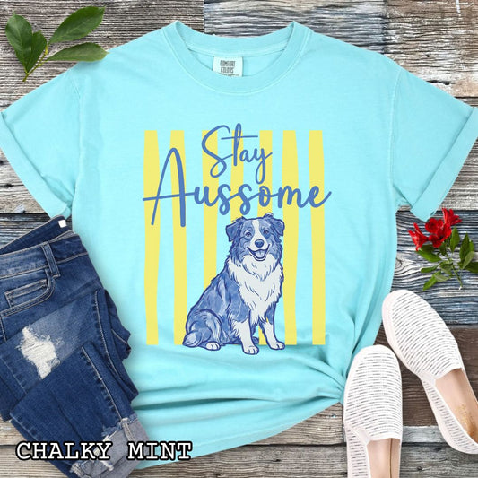 Mint Comfort Colors Australian Shepherd t-shirt featuring Stay Aussome slogan with cute blue merle Aussie illustration, perfect for Aussie moms, herding dog lovers, and Australian Shepherd gifts.